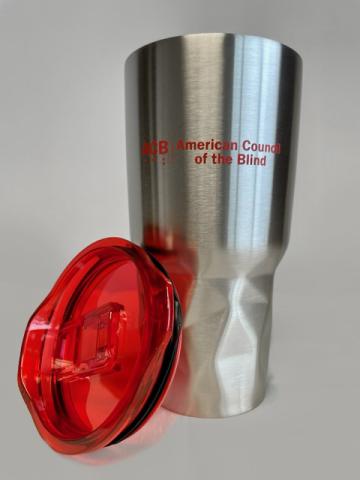 Stainless Steele Tumbler with red lid at side