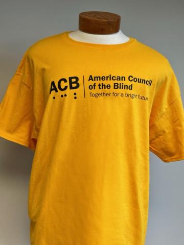 Front view of ACB Authentic T-Shirt in yellow gold with black logo 